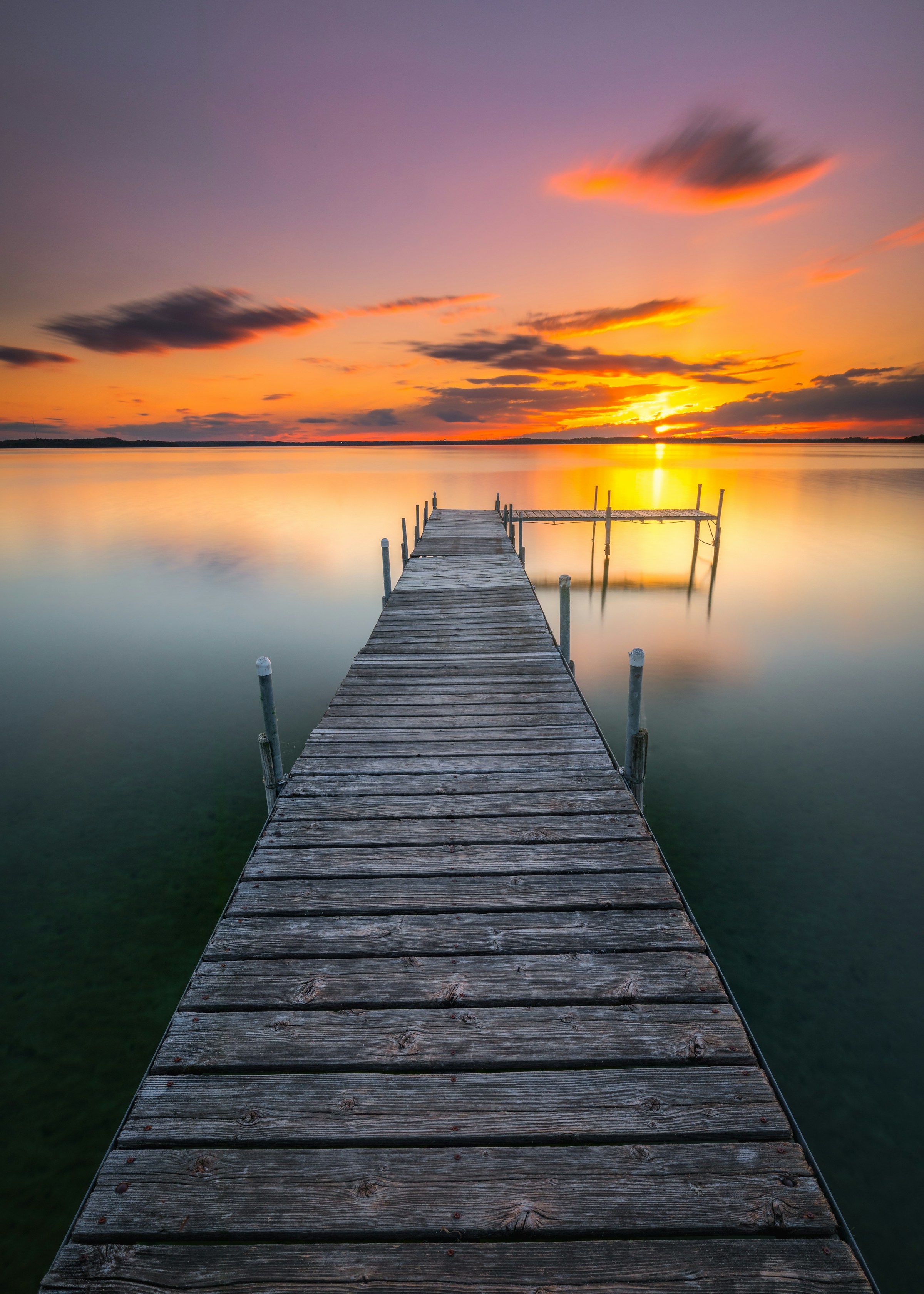 Wooden dock at sunset over the bay